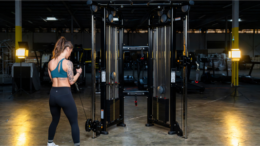 Woman using a cable machine for strength training in a gym setting